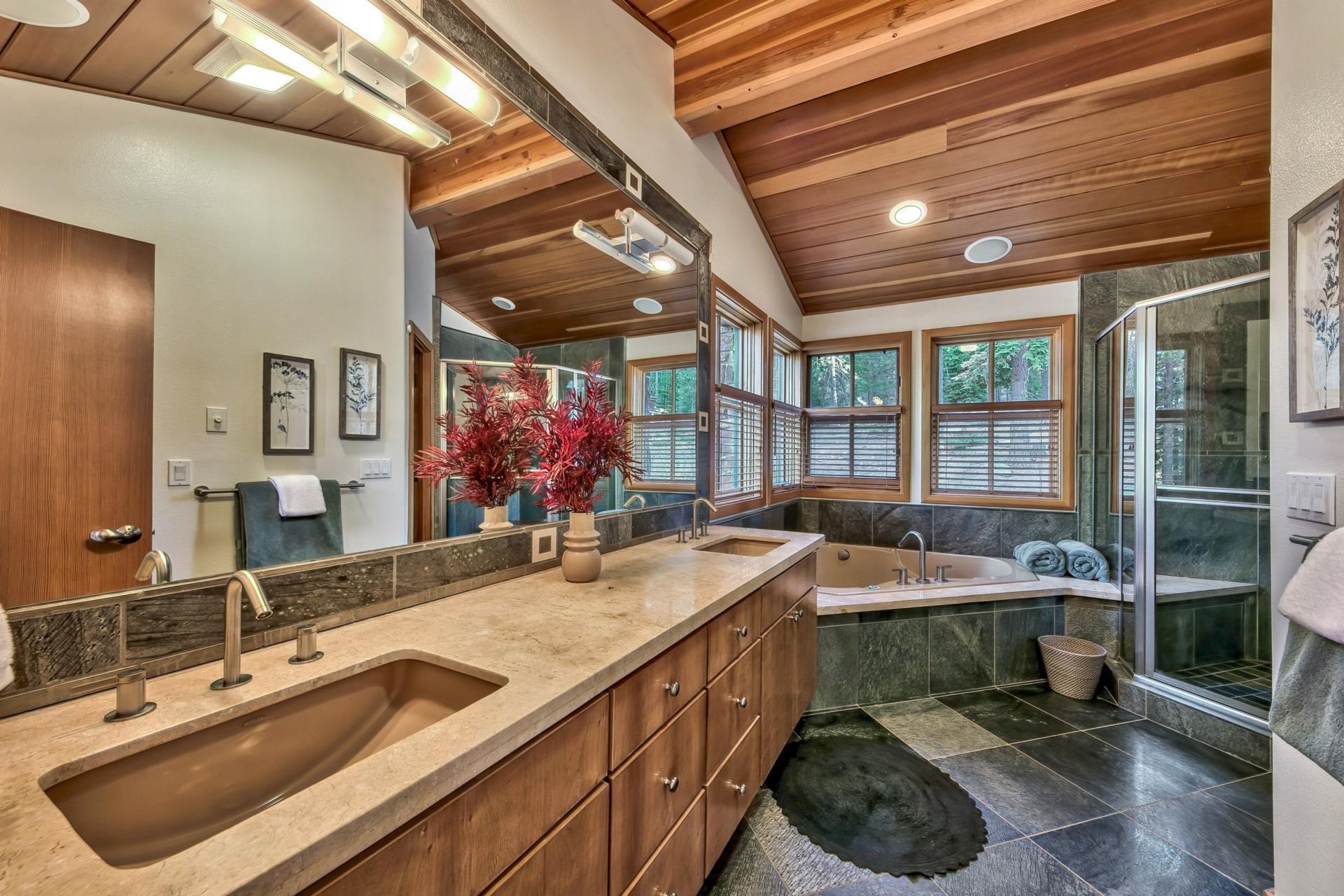 12998 Timber Ridge Road Truckee, CA 96161 - Photo 13 of 21 a en suite bathroom with a sink a large mirror and a bathtub