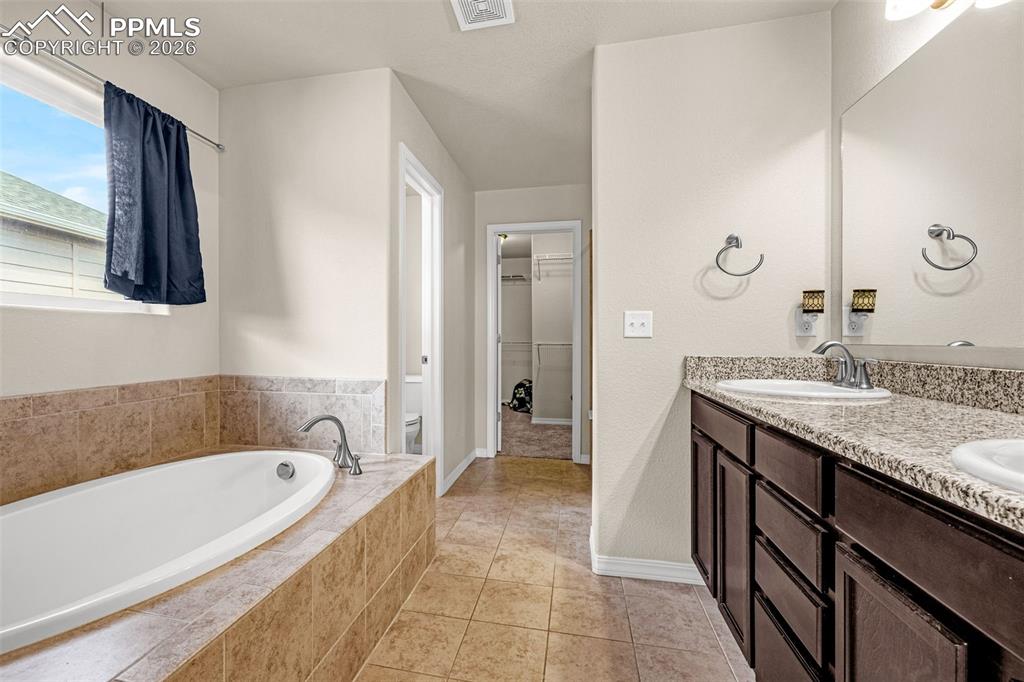 9074 Vanderwood Road Colorado Springs, CO 80908 - Photo 24 of 36 5 piece primary bathroom with walk in closet