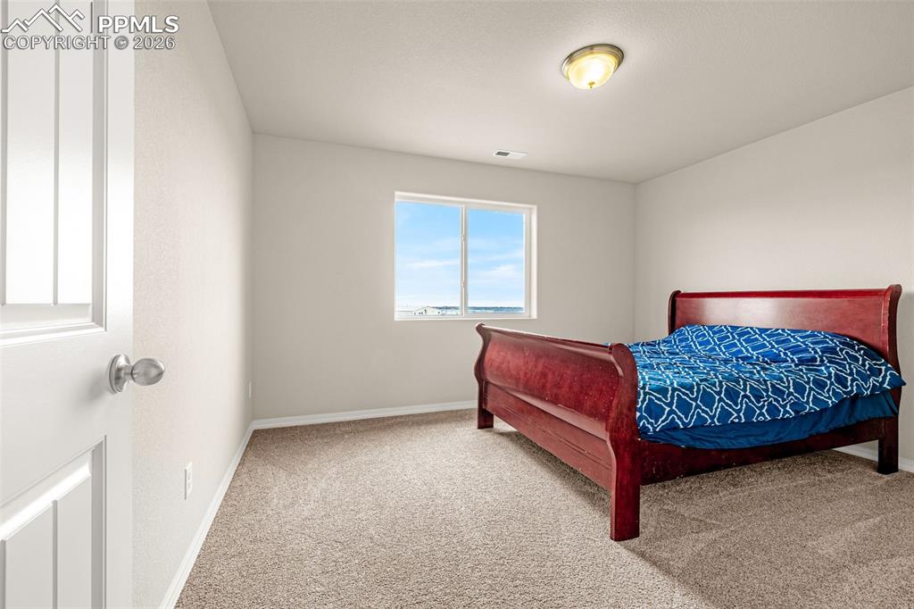 9074 Vanderwood Road Colorado Springs, CO 80908 - Photo 28 of 36 Spacious Secondary bedroom upstairs with walk in closet