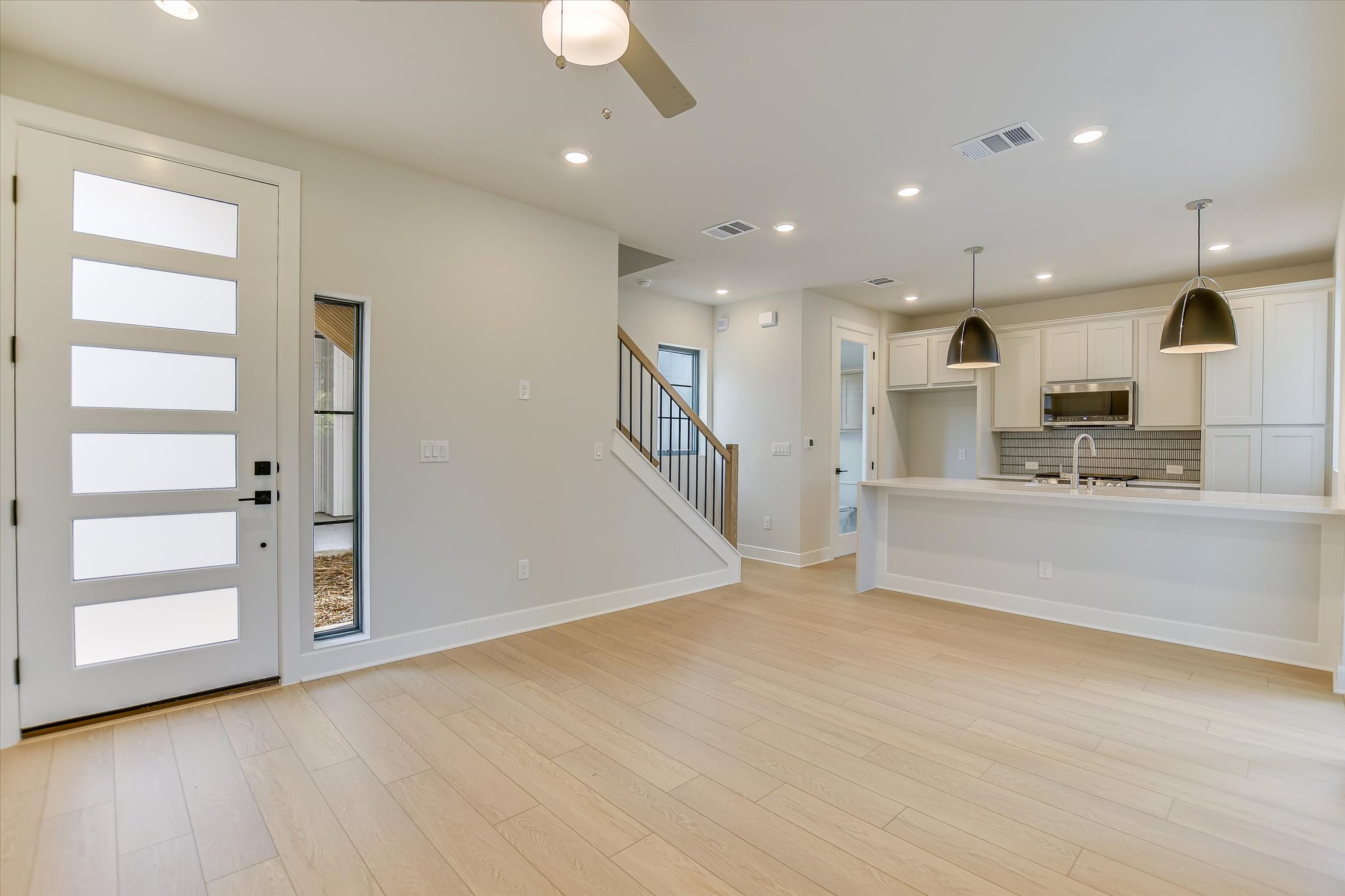 114 Lightsey Road, Unit 2 Austin, TX 78704 - Photo 4 of 14 Unfurnished living room featuring recessed lighting, light wood-style floors, stairway, and a ceiling fan