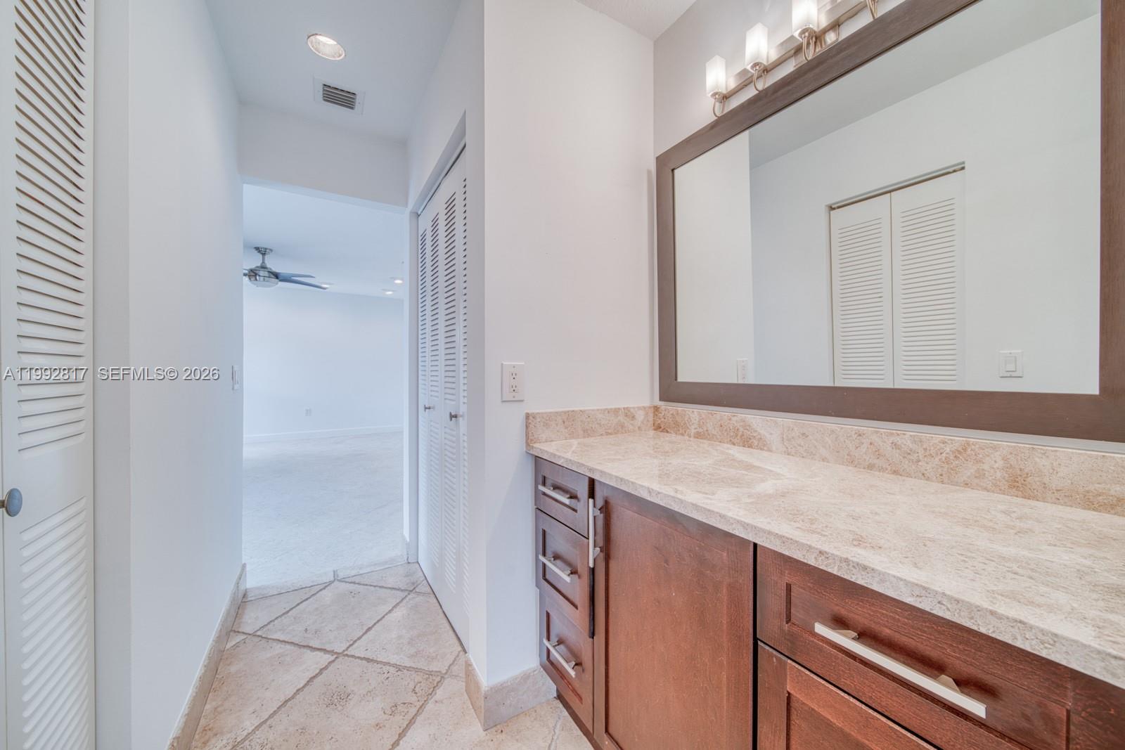 7320 Southwest 100th Court Miami, FL 33173 - Photo 15 of 36 a bathroom with a granite countertop sink and a mirror