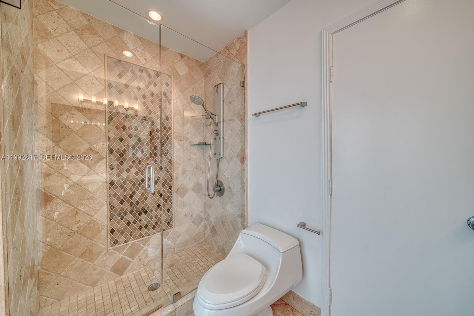 7320 Southwest 100th Court Miami, FL 33173 - Photo 17 of 36 a white toilet and shower curtain