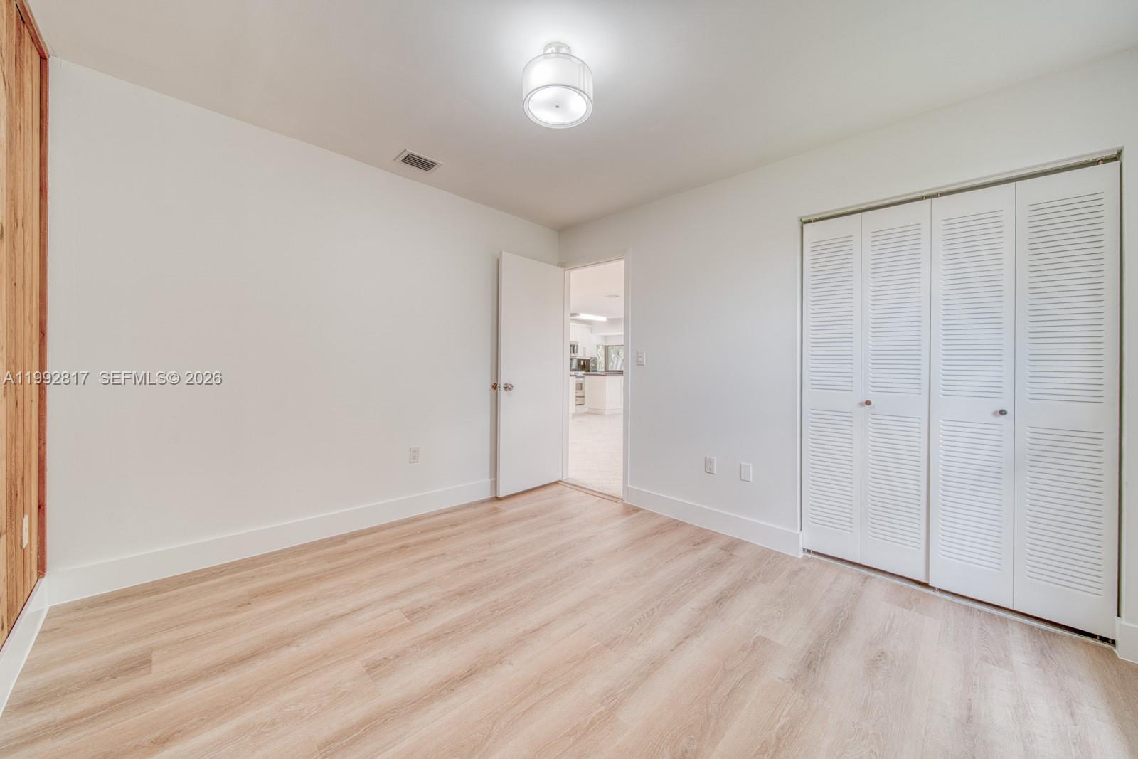 7320 Southwest 100th Court Miami, FL 33173 - Photo 20 of 36 a view of an empty room with wooden floor