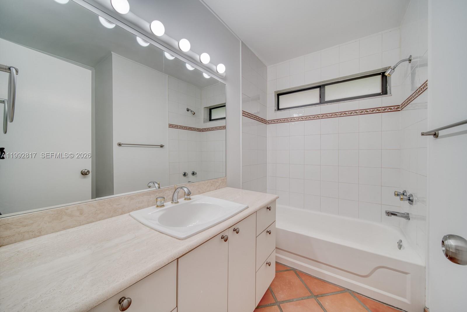7320 Southwest 100th Court Miami, FL 33173 - Photo 23 of 36 a bathroom with a sink double vanity granite tub and shower