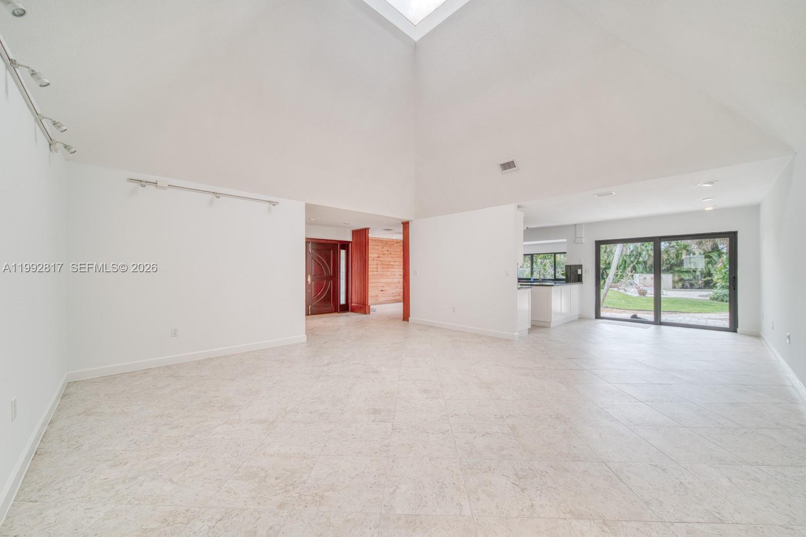 7320 Southwest 100th Court Miami, FL 33173 - Photo 3 of 36 a view of a livingroom with an empty space and a window