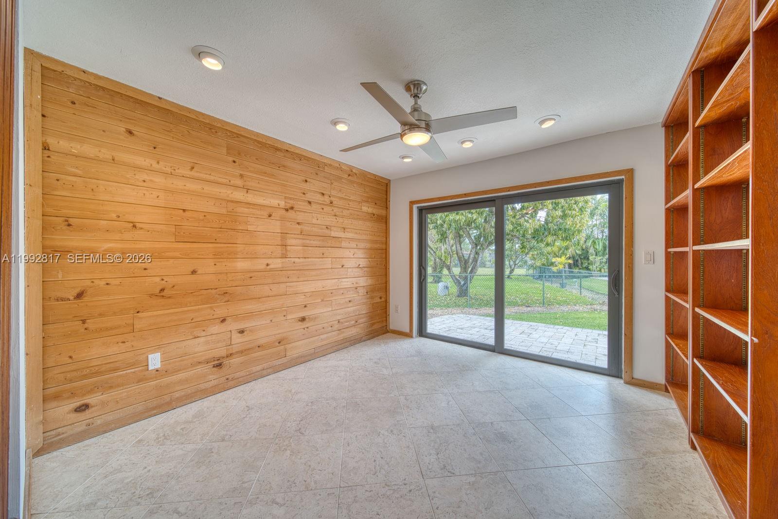 7320 Southwest 100th Court Miami, FL 33173 - Photo 6 of 36 a view of an empty room with a sliding door