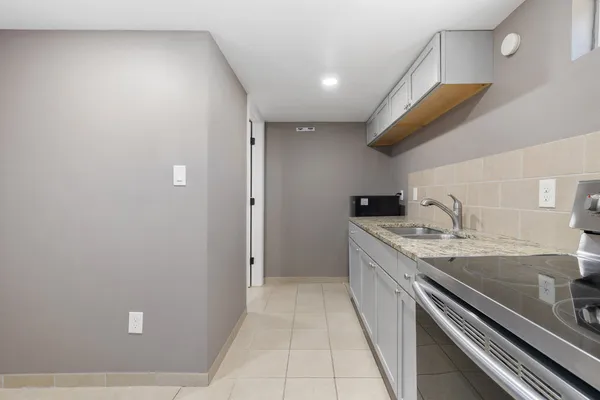 a kitchen with stainless steel appliances granite countertop a sink and cabinets