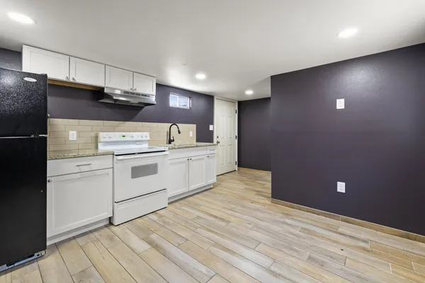 a kitchen with a stove cabinets and refrigerator