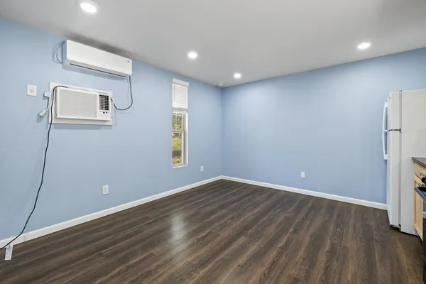 a kitchen with a refrigerator and a stove top oven
