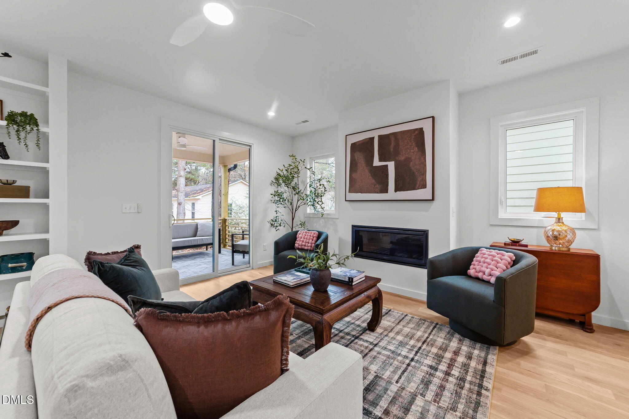a living room with furniture fireplace and window