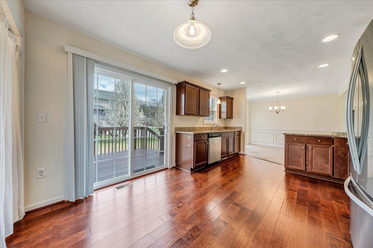 427 Cambridge Ct Road Vinton, VA 24179 - Photo 18 of 46 a living room with stainless steel appliances furniture a large window and wooden floor