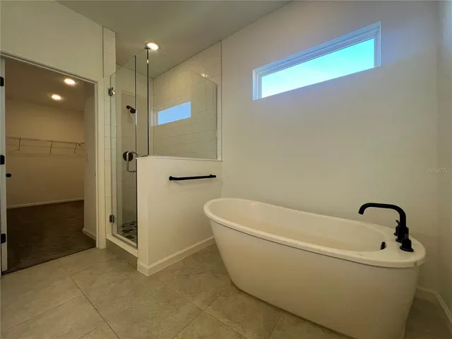 a bathroom with a bathtub and a shower