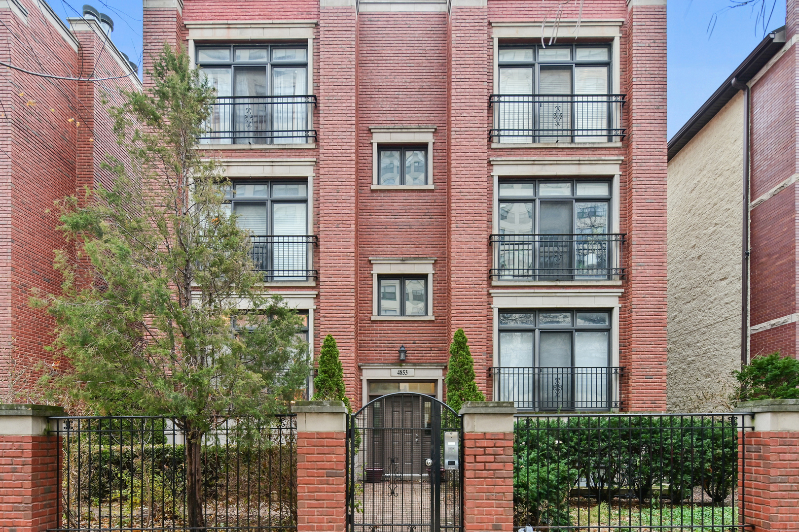 front view of a brick house with a large windows