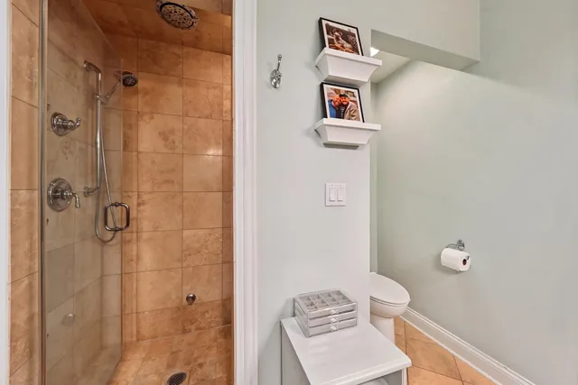 a bathroom with a toilet and a shower