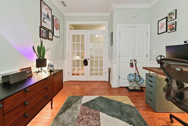 a large room with a couch and a potted plant on the dresser