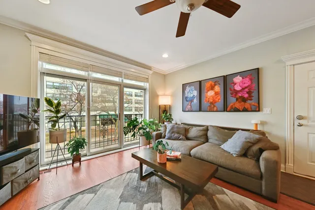 a living room with furniture a flat screen tv and a large window