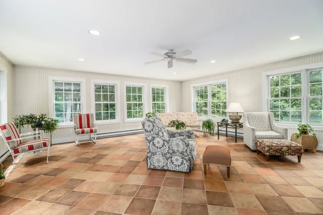 a kitchen with cabinets appliances wooden floor and a window