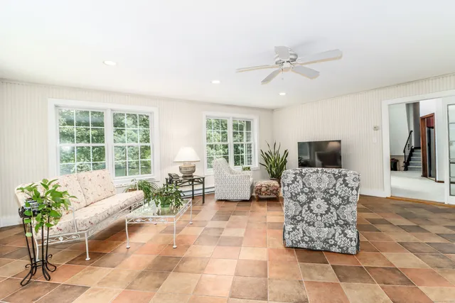 a kitchen with stainless steel appliances granite countertop a kitchen island a stove a dining table and chairs