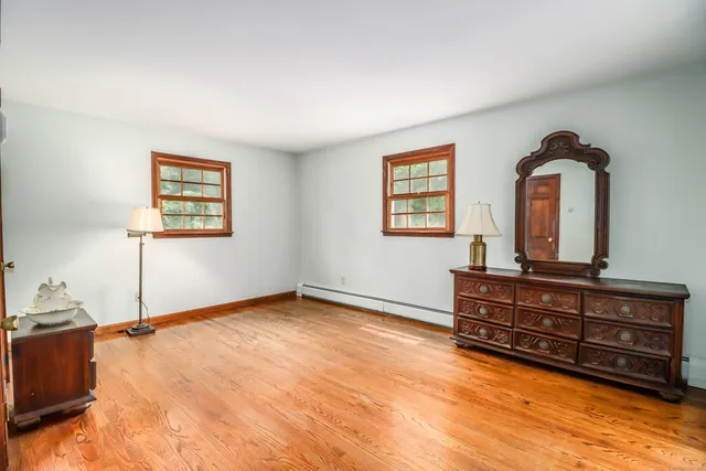 a large bed sitting in a bedroom next to a bathroom