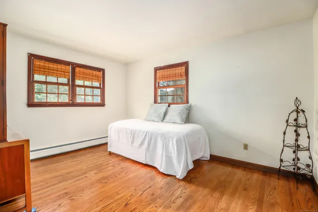 a living room with furniture a large window and a fireplace