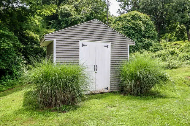 a living room with furniture a fireplace and a large window