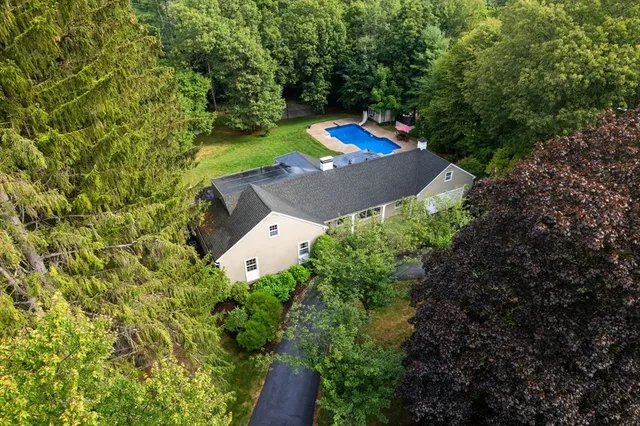 an aerial view of a house with a yard