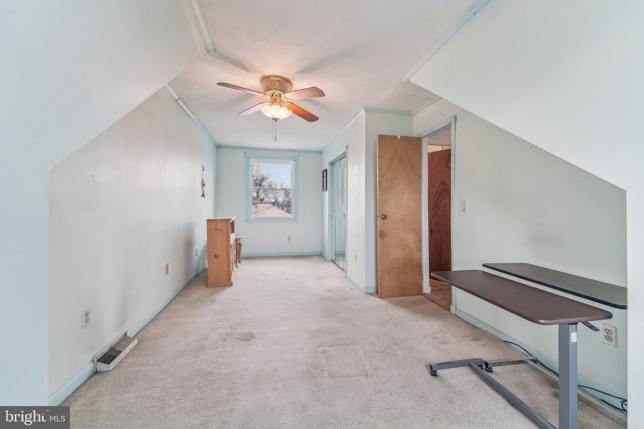 8218 Longpoint Road Dundalk, MD 21222 - Photo 15 of 30 an empty room with windows and fan