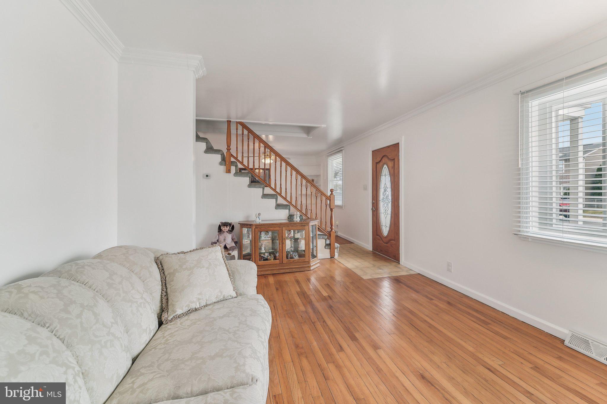 8218 Longpoint Road Dundalk, MD 21222 - Photo 5 of 30 a living room with stairs and a wooden floor