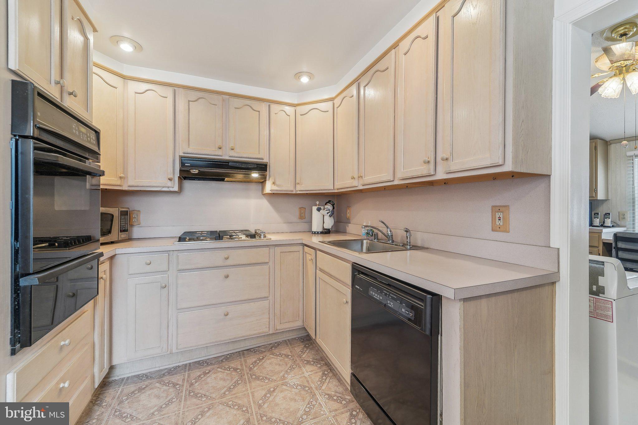 8218 Longpoint Road Dundalk, MD 21222 - Photo 10 of 30 a kitchen with stainless steel appliances granite countertop a sink stove and refrigerator