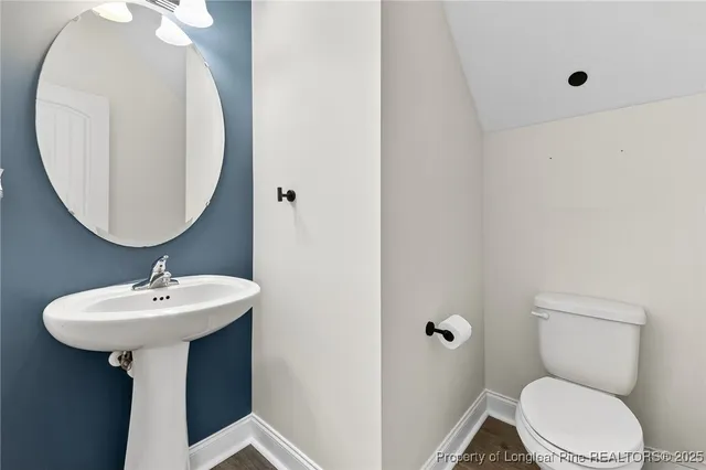 a bathroom with a sink a mirror and toilet
