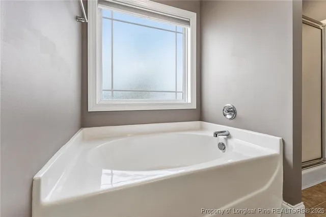 a white bath tub sitting next to a window