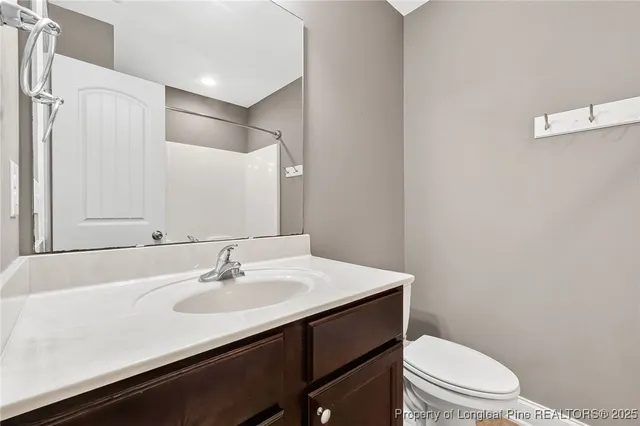 a bathroom with a sink toilet and a mirror