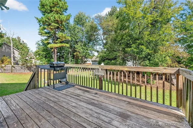 a view of balcony with wooden floor and fence