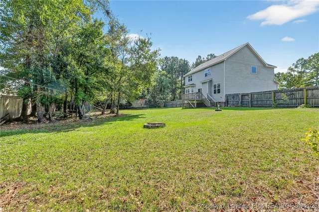a view of a house with a yard and sitting area