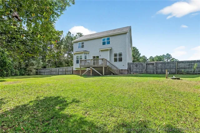 a view of a house with a backyard