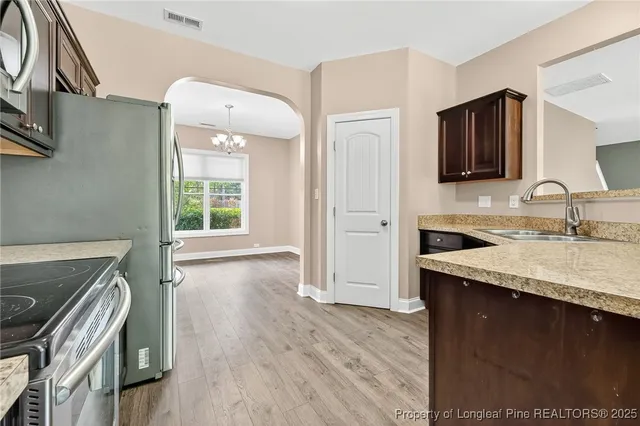 a kitchen with a sink stove and cabinets