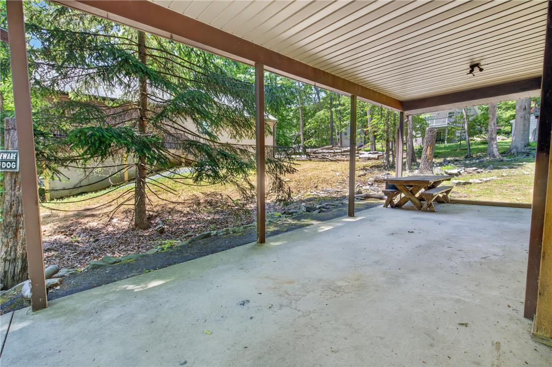 18 White Oak Road Nesquehoning, PA 18240 - Photo 35 of 52 A spacious covered patio offers a refreshing outdoor retreat with views of the natural landscape.