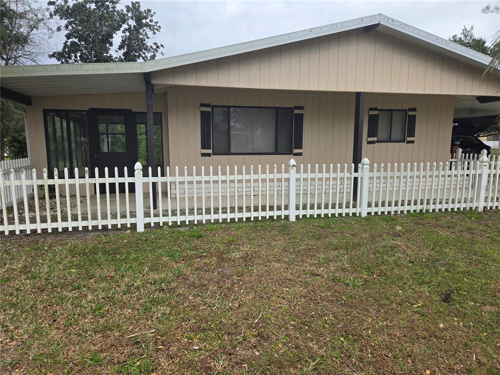 10040 Southwest 98th Avenue Ocala, FL 34481 - Photo 2 of 28 a front view of a house with garden