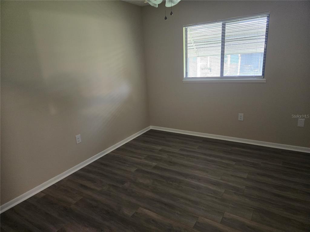 10040 Southwest 98th Avenue Ocala, FL 34481 - Photo 21 of 28 an empty room with wooden floor and windows