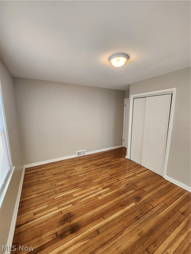 2199 North Taylor Road Cleveland Heights, OH 44112 - Photo 12 of 19 Unfurnished bedroom with a closet and hardwood / wood-style floors