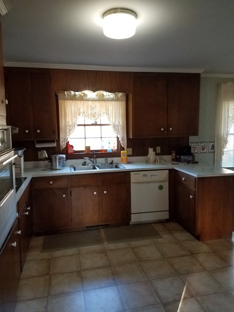174 Hampton Hills Road Gray, GA 31032 - Photo 3 of 31 a kitchen with a sink a stove a microwave and cabinets