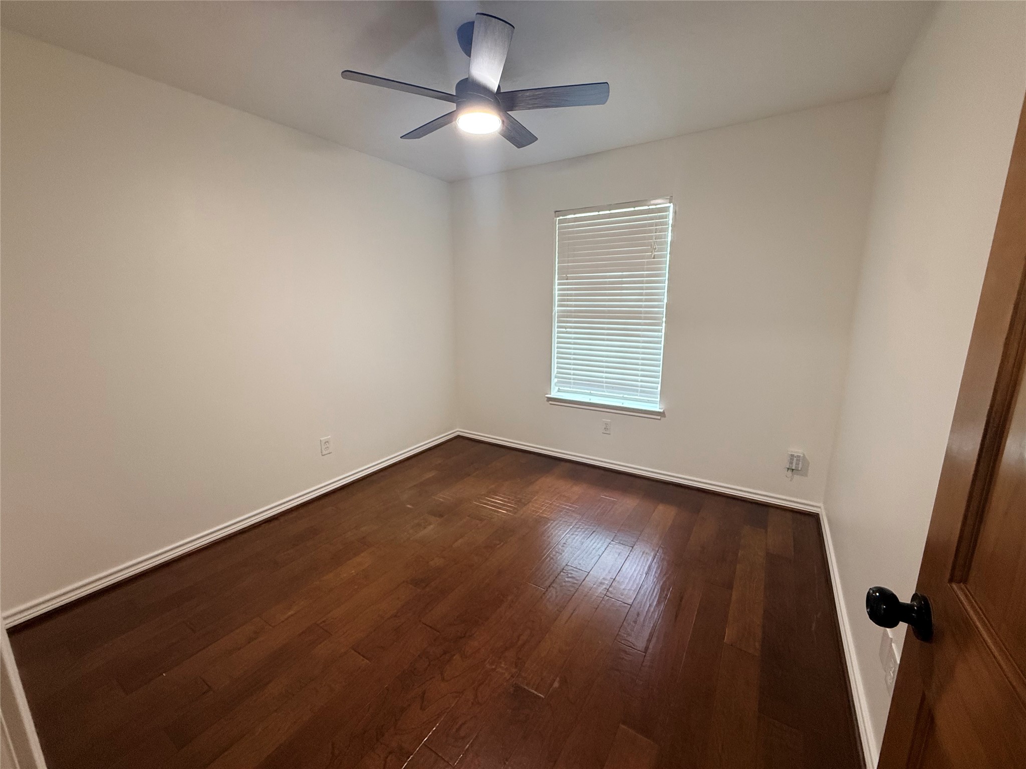 855 County Road 2267 Cleveland, TX 77327 - Photo 13 of 24 wooden floor in an empty room with a window