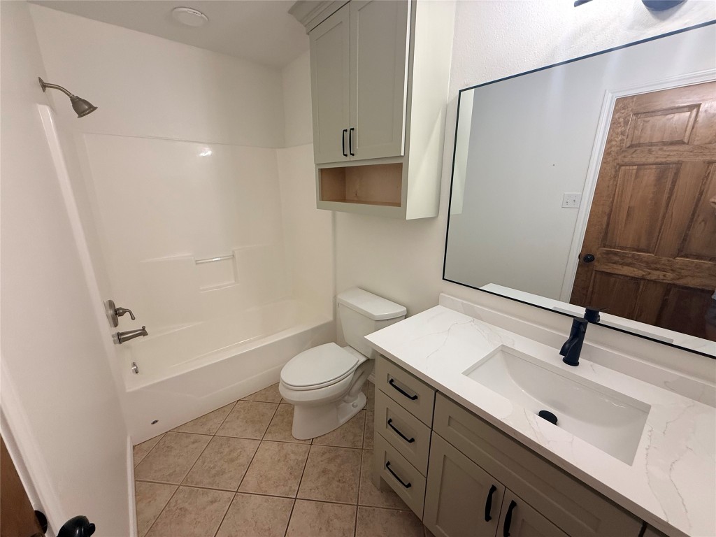 855 County Road 2267 Cleveland, TX 77327 - Photo 16 of 24 a bathroom with a sink toilet a mirror and shower