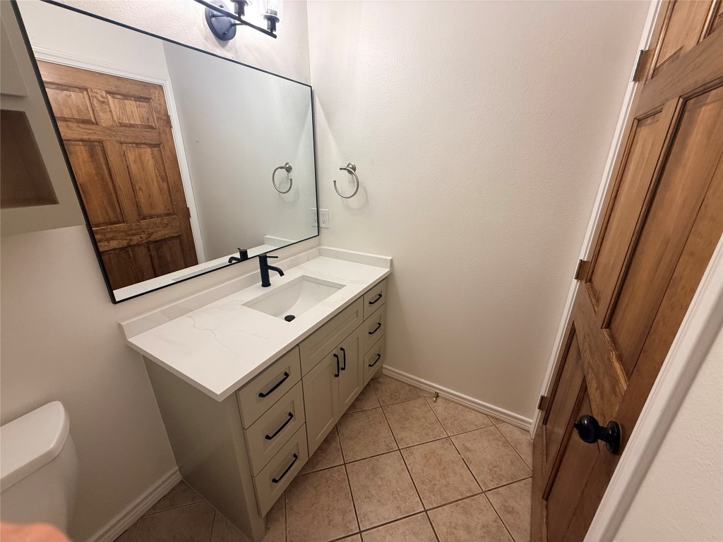 855 County Road 2267 Cleveland, TX 77327 - Photo 17 of 24 a bathroom with a sink toilet and mirror