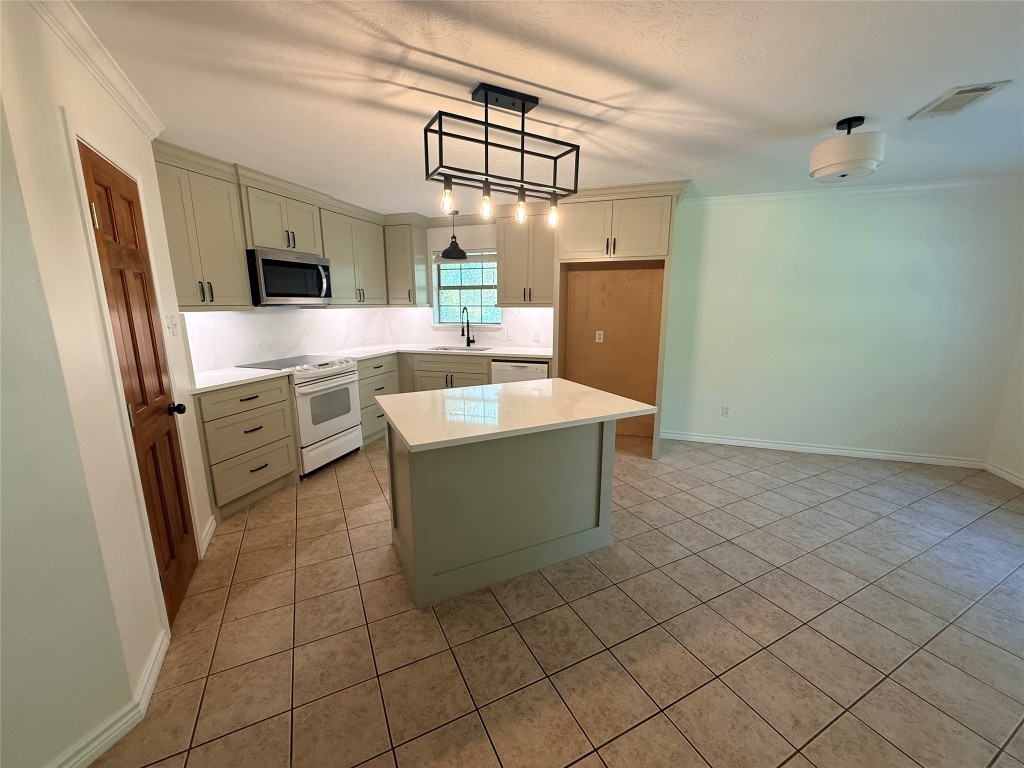 855 County Road 2267 Cleveland, TX 77327 - Photo 20 of 24 a kitchen with stainless steel appliances a sink and a refrigerator