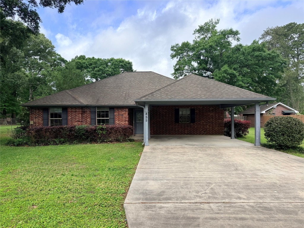 855 County Road 2267 Cleveland, TX 77327 - Photo 2 of 24 a front view of a house with a yard and trees