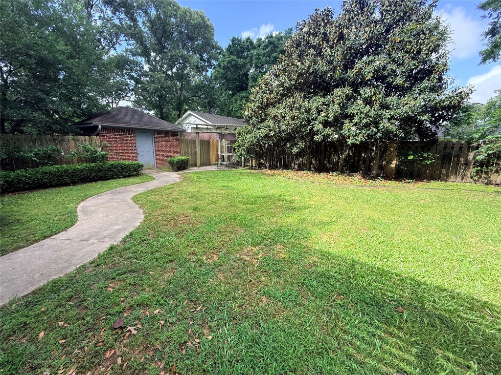 855 County Road 2267 Cleveland, TX 77327 - Photo 21 of 24 a view of a house with backyard and garden