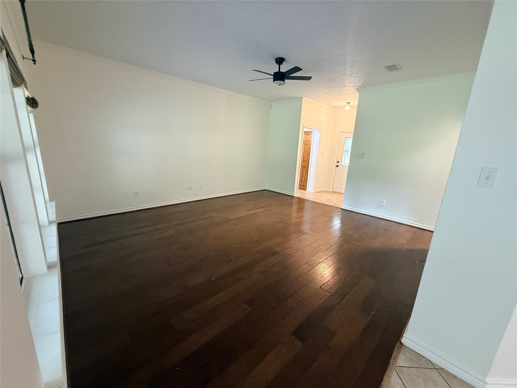 855 County Road 2267 Cleveland, TX 77327 - Photo 4 of 24 an empty room with wooden floor and windows