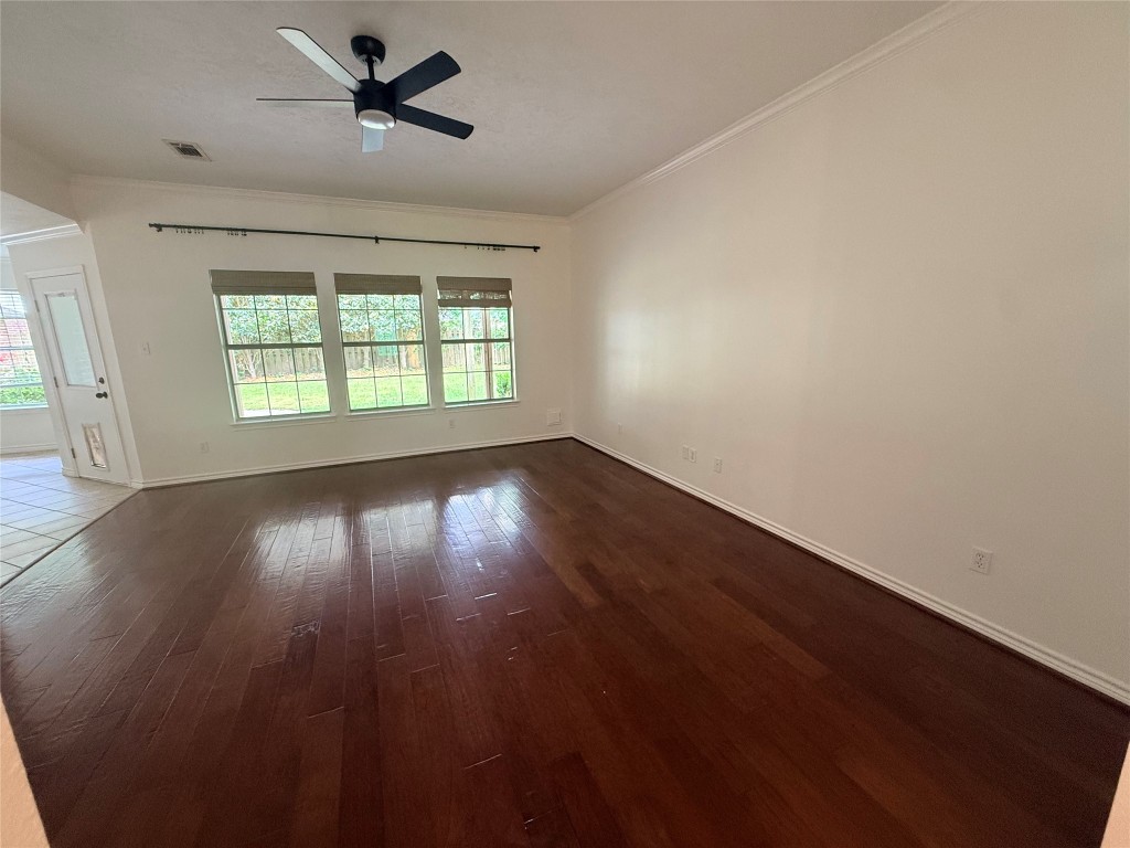 855 County Road 2267 Cleveland, TX 77327 - Photo 5 of 24 an empty room with wooden floor and windows
