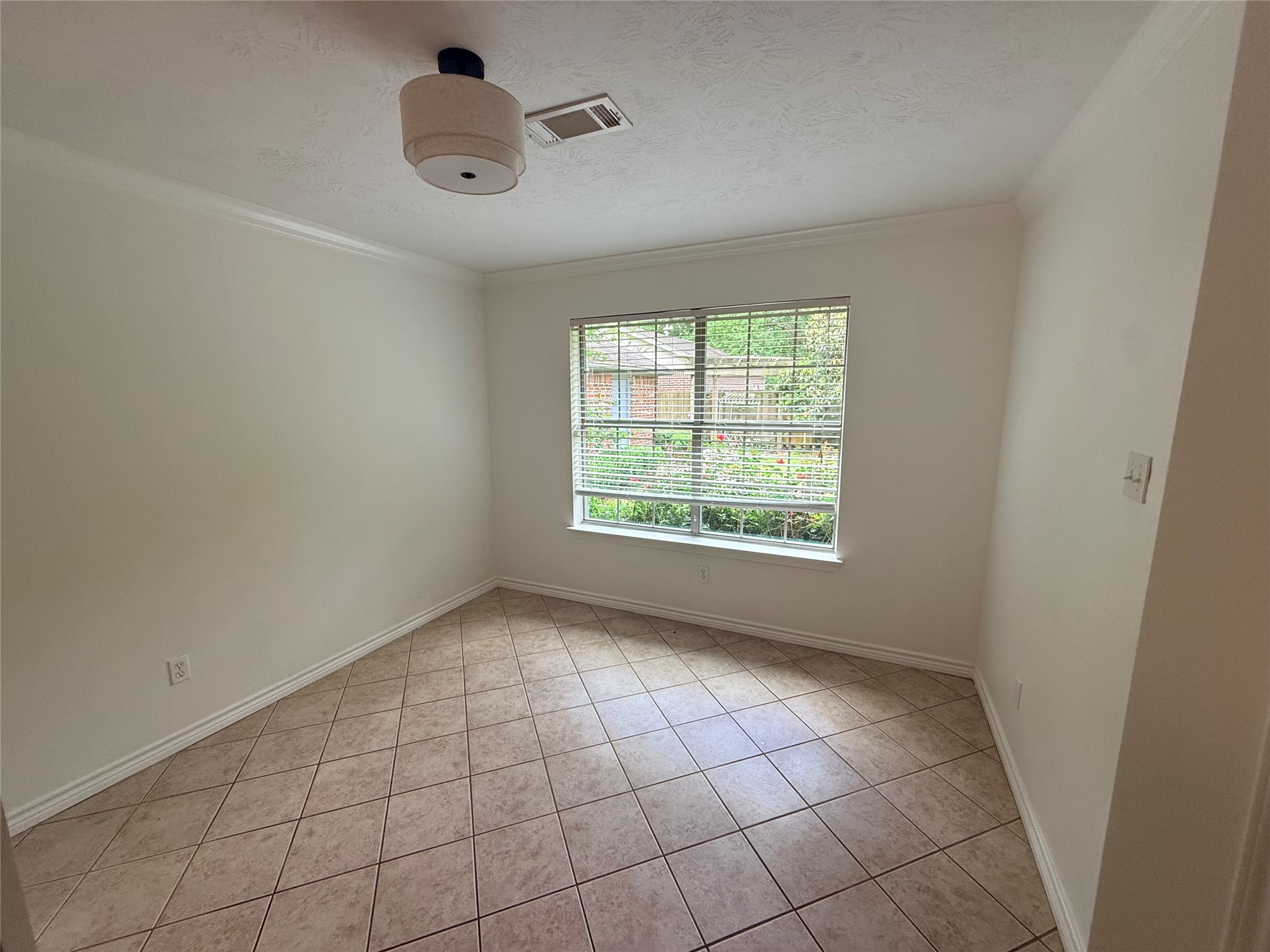 855 County Road 2267 Cleveland, TX 77327 - Photo 10 of 24 an empty room with windows and fan
